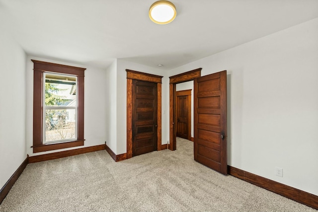 unfurnished bedroom with baseboards and carpet