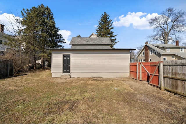 back of house with a yard and fence