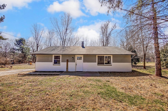 view of front of house with a chimney and a front yard