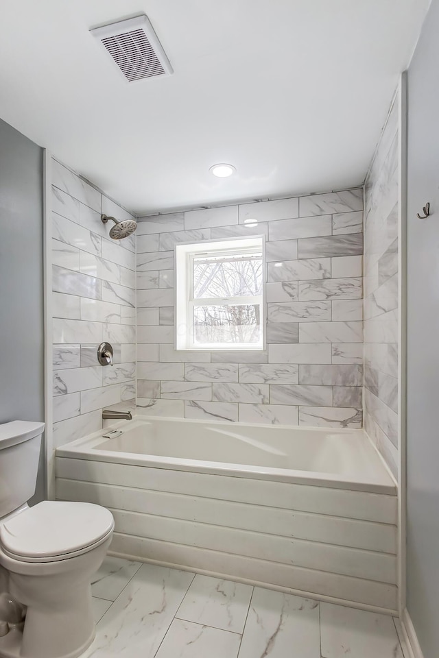 bathroom with tub / shower combination, visible vents, toilet, and marble finish floor