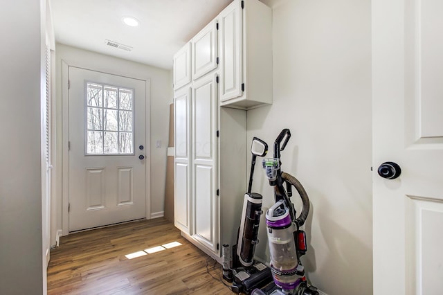 doorway with visible vents and wood finished floors