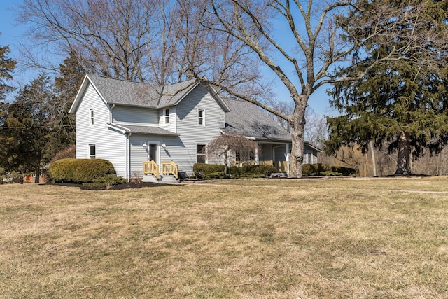 exterior space with a front yard and roof with shingles