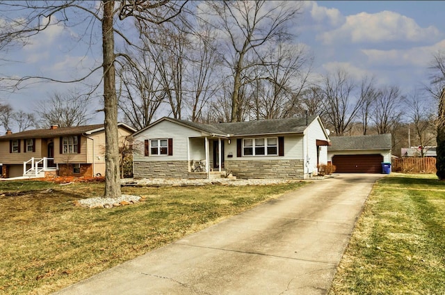 view of front facade featuring a front yard, a garage, stone siding, and an outdoor structure