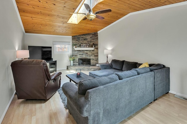 living area featuring lofted ceiling with skylight, wood ceiling, ornamental molding, and light wood finished floors