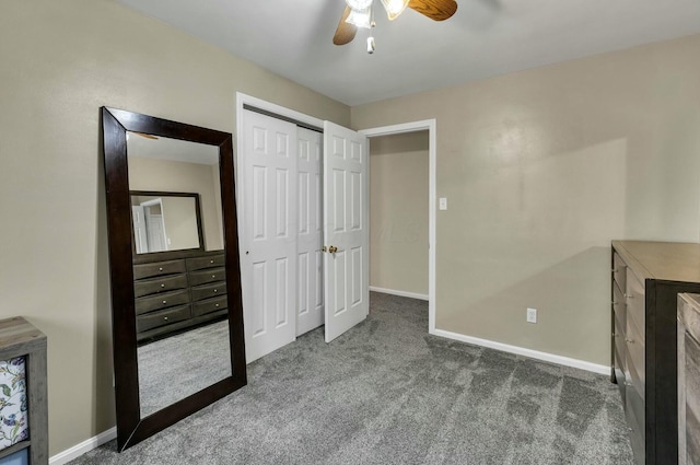 unfurnished bedroom with a closet, baseboards, carpet floors, and ceiling fan