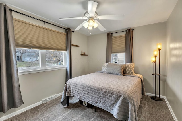 bedroom featuring visible vents, multiple windows, baseboards, and carpet