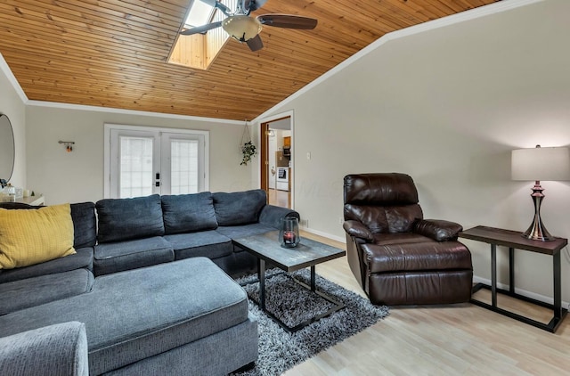 living area with wood ceiling, ornamental molding, vaulted ceiling with skylight, french doors, and wood finished floors