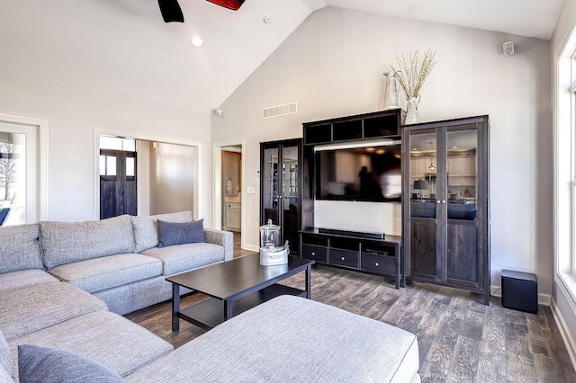 living room with visible vents, high vaulted ceiling, ceiling fan, and wood finished floors