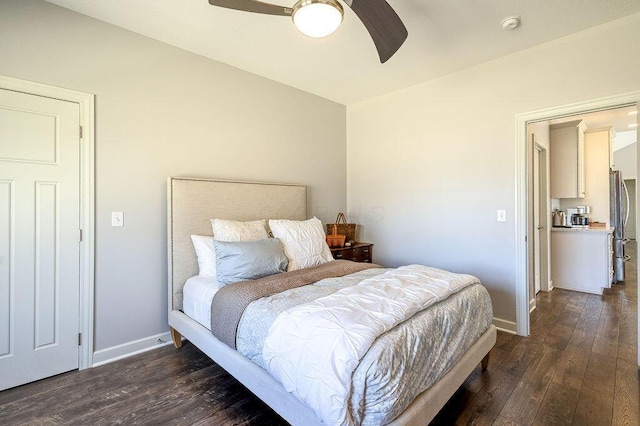 bedroom with a ceiling fan, freestanding refrigerator, baseboards, and hardwood / wood-style flooring