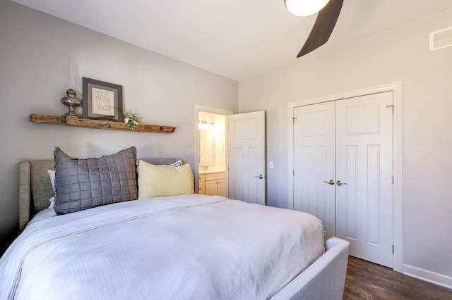 bedroom with visible vents, dark wood-type flooring, a ceiling fan, a closet, and baseboards