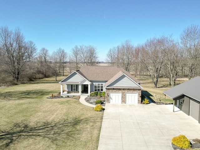 view of front of house with driveway, stone siding, covered porch, a front yard, and a garage