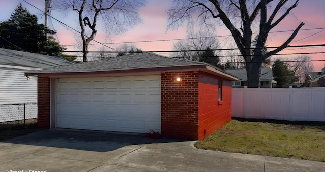 detached garage featuring fence