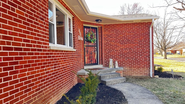 doorway to property with brick siding