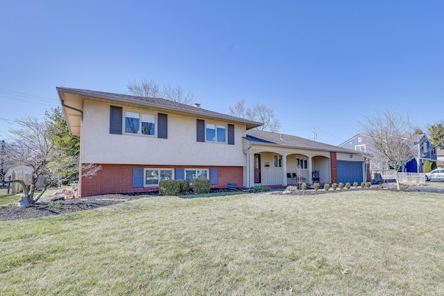 tri-level home with brick siding, a garage, and a front lawn