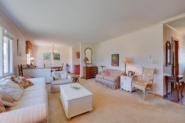 living room with crown molding, light colored carpet, baseboards, and a chandelier