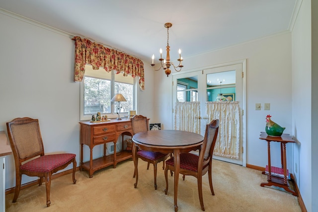 dining room with baseboards, light colored carpet, an inviting chandelier, and crown molding