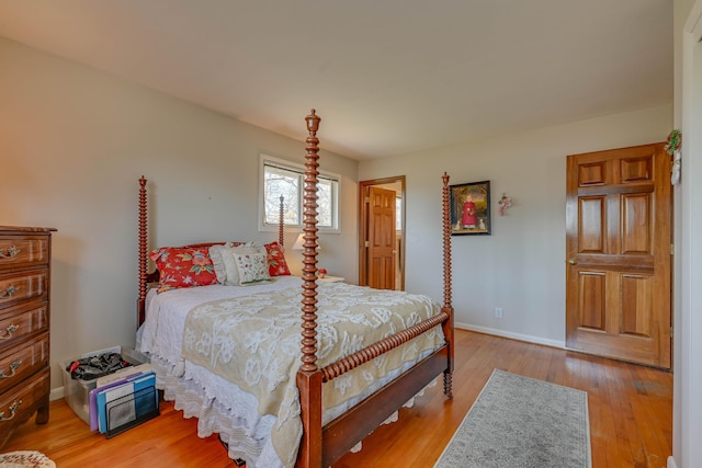 bedroom with baseboards and light wood finished floors