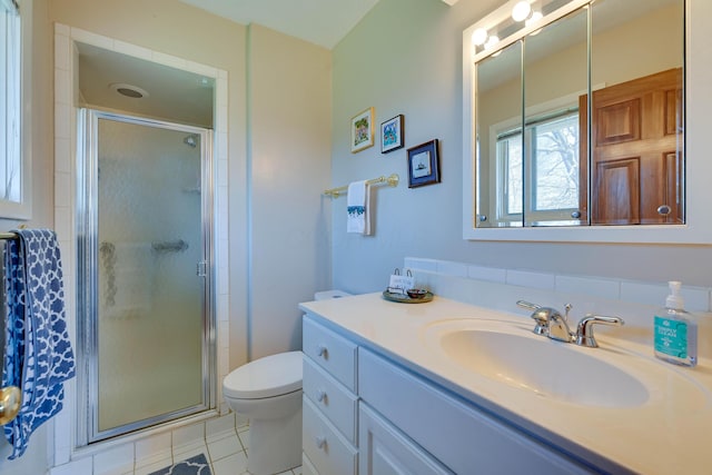 bathroom with vanity, a shower stall, toilet, and tile patterned floors