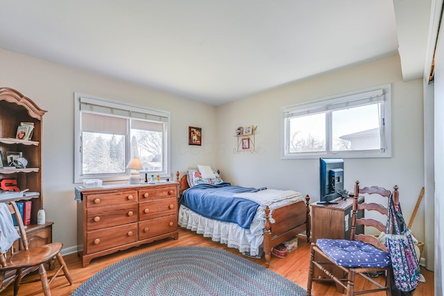 bedroom featuring baseboards and light wood-type flooring