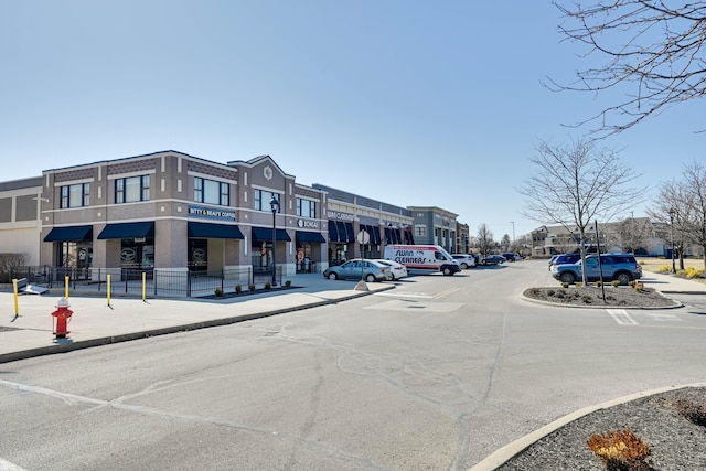 view of street featuring curbs, street lighting, and sidewalks