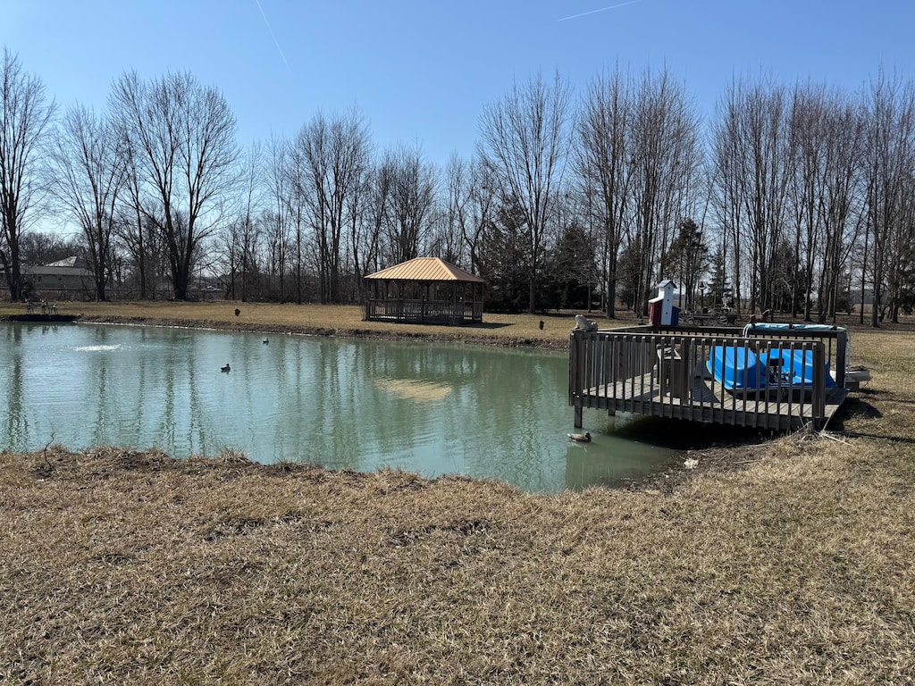 view of dock featuring a gazebo and a water view