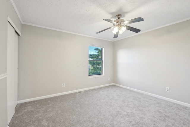 unfurnished bedroom with baseboards, carpet floors, a textured ceiling, and ornamental molding