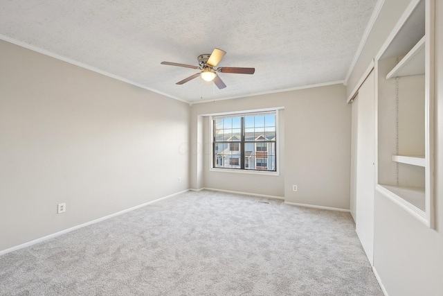 unfurnished bedroom featuring carpet floors, a textured ceiling, and ornamental molding