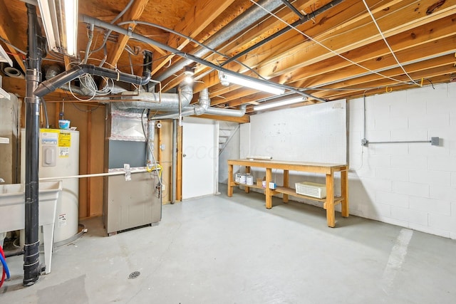 unfinished basement featuring heating unit and electric water heater