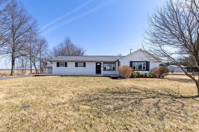 single story home featuring metal roof and a front yard