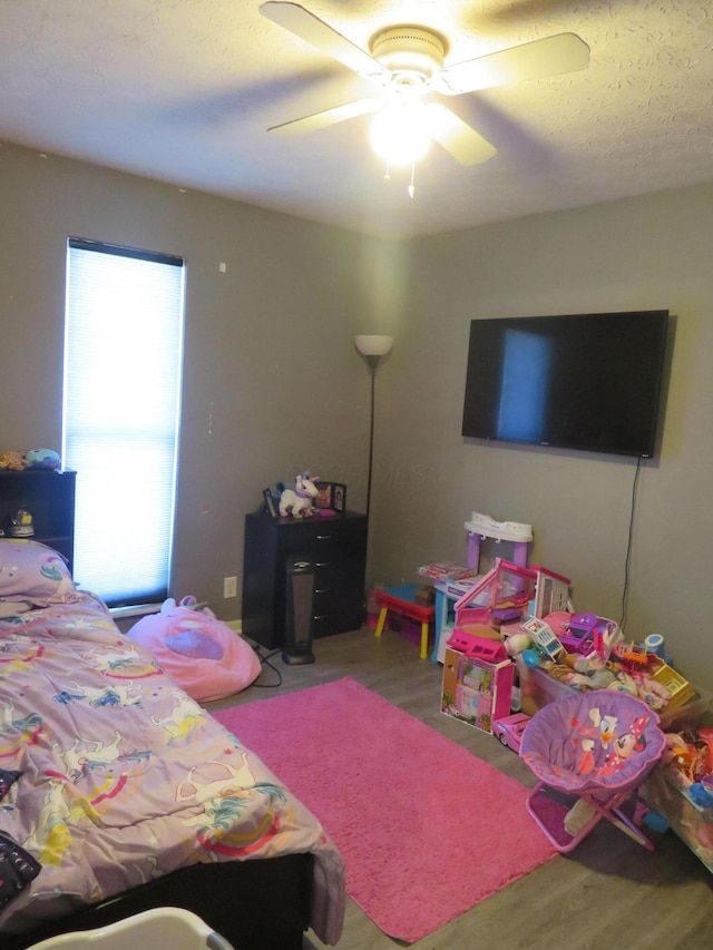 bedroom featuring a ceiling fan and wood finished floors