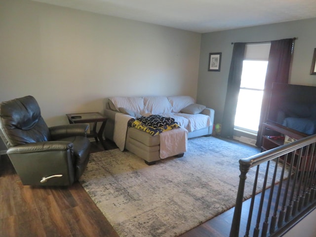 living area with stairway and wood finished floors