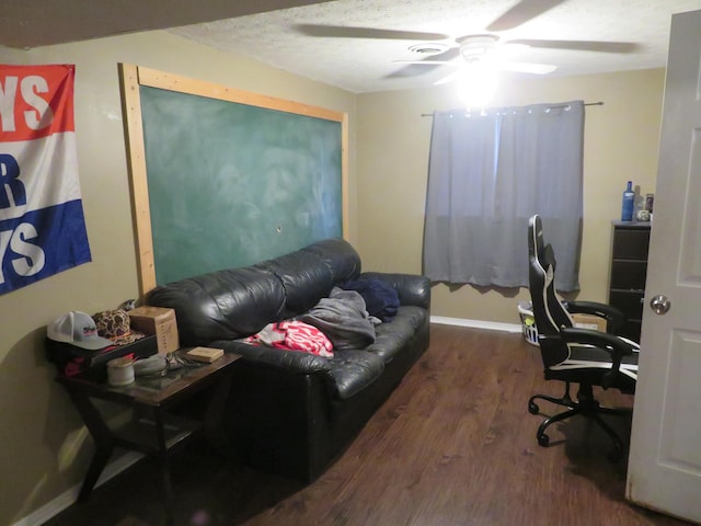 office area with baseboards, a textured ceiling, a ceiling fan, and wood finished floors