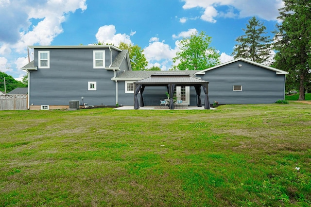 back of property featuring a gazebo, a yard, a patio area, and fence