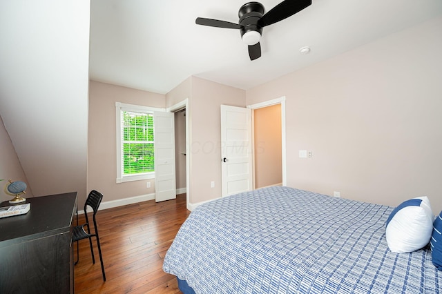 bedroom with baseboards, wood-type flooring, and a ceiling fan