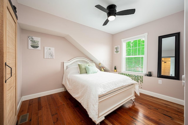 bedroom featuring visible vents, a ceiling fan, baseboards, and hardwood / wood-style floors