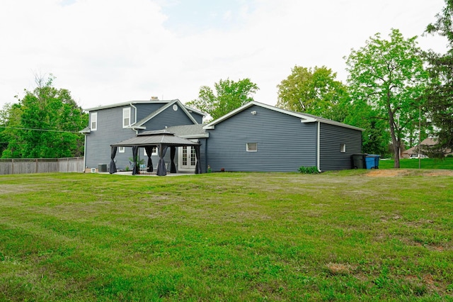 back of house featuring a gazebo, a yard, a patio area, and fence