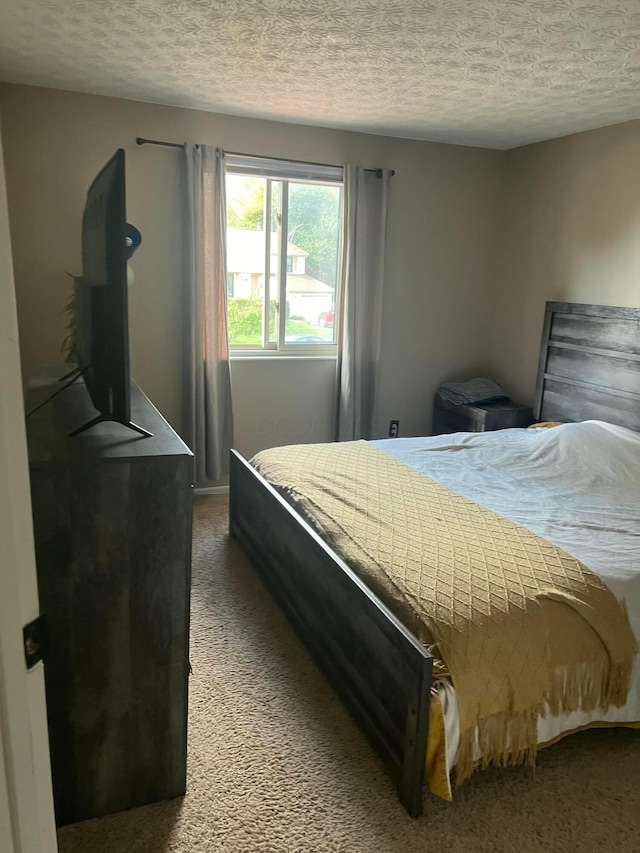 carpeted bedroom featuring a textured ceiling