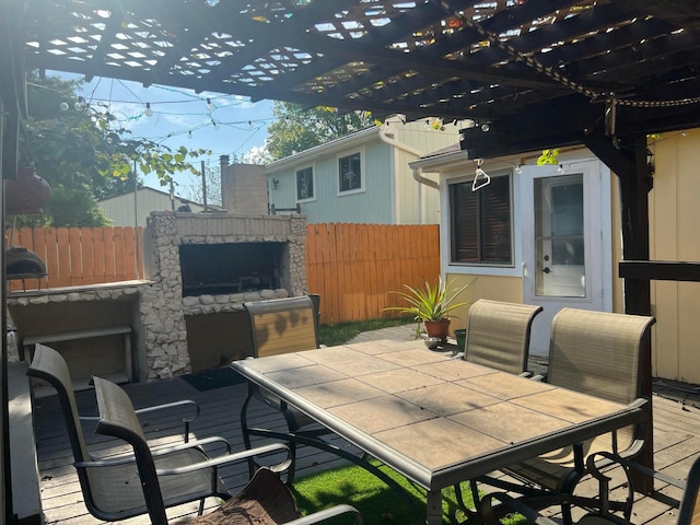 view of patio with outdoor dining space, fence, and a pergola