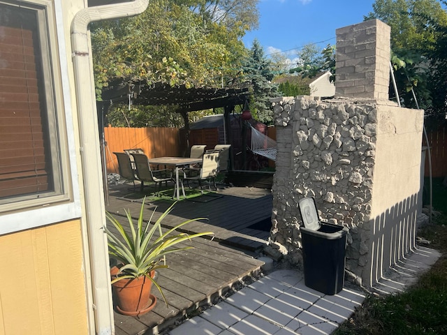 view of patio featuring a pergola, outdoor dining area, and fence