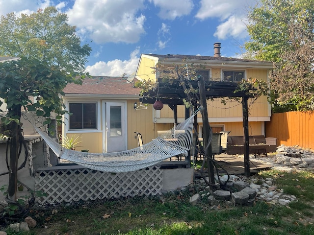 rear view of property featuring fence