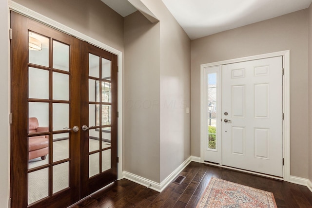 foyer entrance with visible vents, french doors, dark wood-style flooring, and baseboards