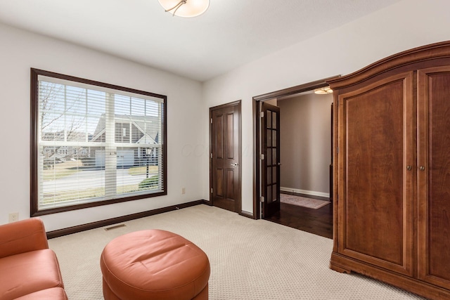 unfurnished room featuring light colored carpet, baseboards, and visible vents