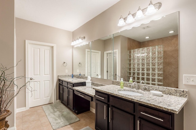 bathroom with visible vents, walk in shower, baseboards, tile patterned floors, and vanity