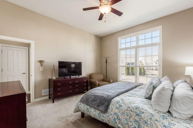 bedroom featuring visible vents, light carpet, a ceiling fan, baseboards, and vaulted ceiling