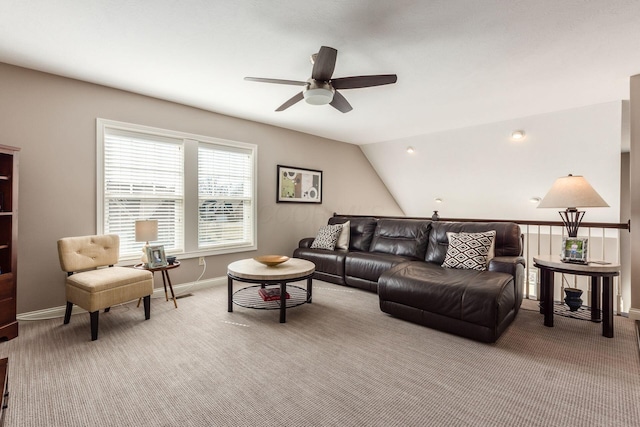 living room with baseboards, carpet, ceiling fan, and vaulted ceiling