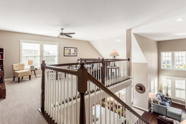 hallway featuring an upstairs landing, baseboards, and a healthy amount of sunlight