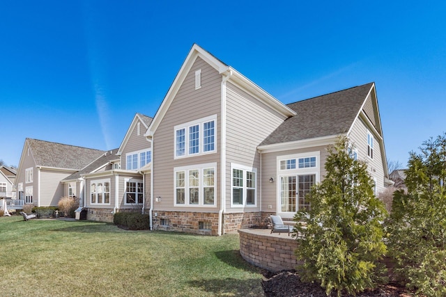 rear view of property with a yard and a patio area