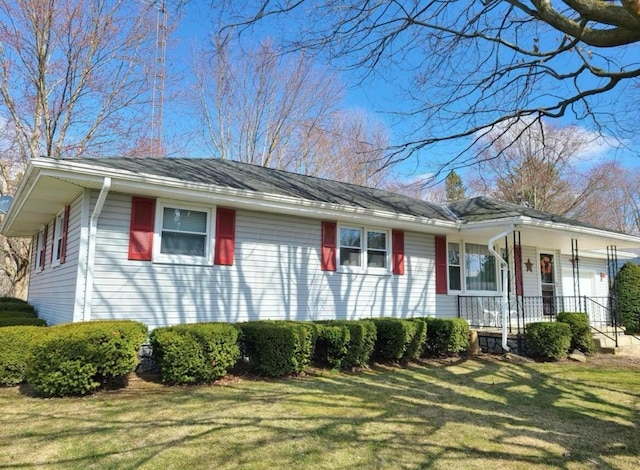 ranch-style house featuring a porch and a front yard