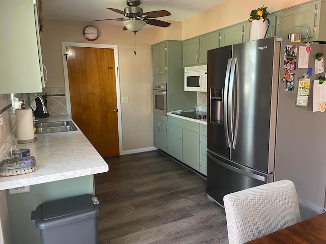 kitchen with green cabinets, ceiling fan, dark wood finished floors, light countertops, and stainless steel appliances