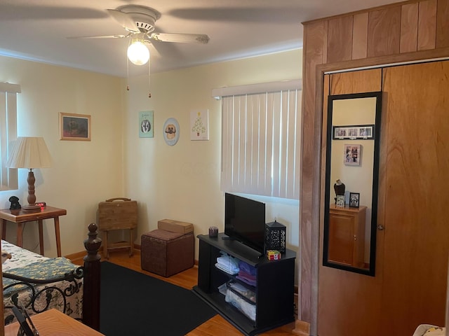 living area featuring a ceiling fan and wood finished floors